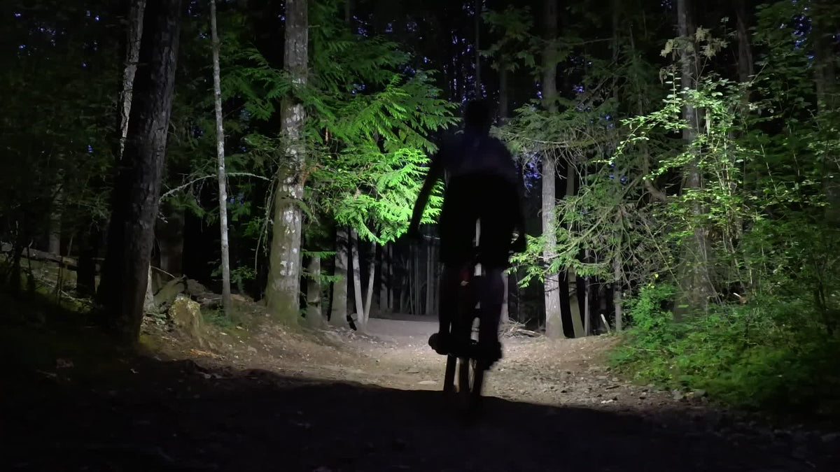 MB6 beam illuminating the width of a forest trail at dusk
